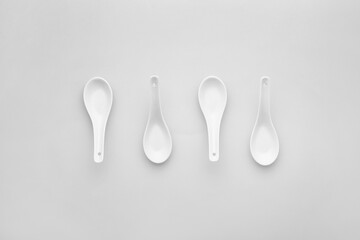 Clean spoons on grey background