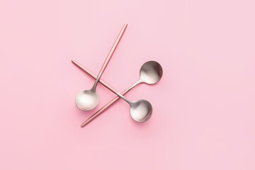 Clean spoons on color background