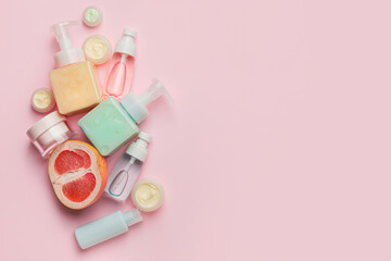 Natural cosmetic products with citrus fruit on color background