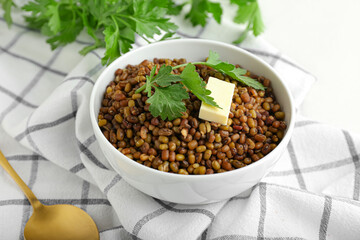 Bowl of tasty cooked lentils on table