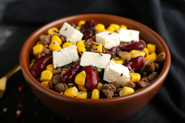 Bowl of tasty cooked lentils, beans and cheese on table