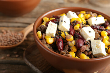 Bowl of tasty cooked lentils, beans and cheese on table, closeup