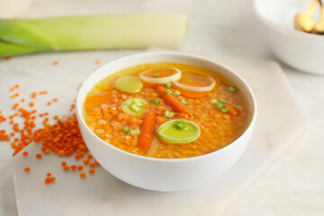 Bowl of tasty lentil soup on table