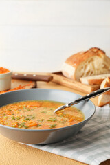 Bowl of tasty lentil soup on table