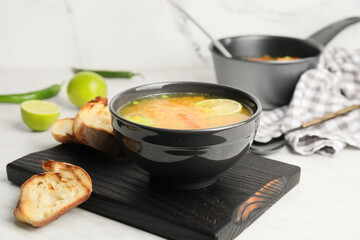 Bowl of tasty lentil soup on table