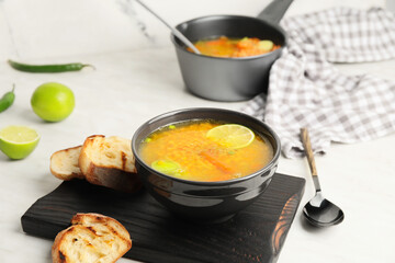 Bowl of tasty lentil soup on table