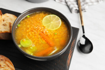 Bowl of tasty lentil soup on table