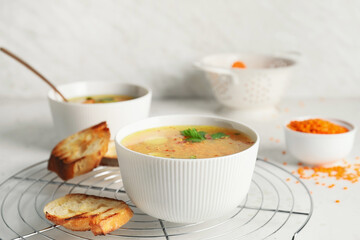 Bowl of tasty lentil soup on table