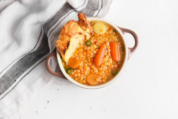 Pot of tasty lentil soup on table