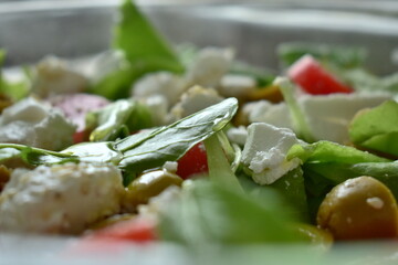 Greek salad with feta cheese, olives, lettuce, tomatoes