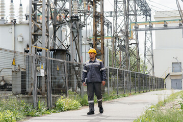 An engineering employee makes a tour and inspection of a modern electrical substation. Energy....