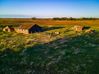 An aerial view of an old farm yard that has been abandoned, forgotten, and left to be reclaimed by nature. This farm was used by the farming settlers of the Saskatchewan Prairies in the early 1900's.