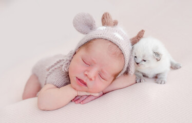 Newborn sleeping with kitten © tan4ikk