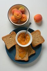 apricot jam with rusk for breakfast - closeup