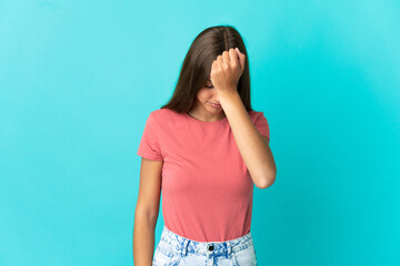 Young woman over isolated blue background with headache