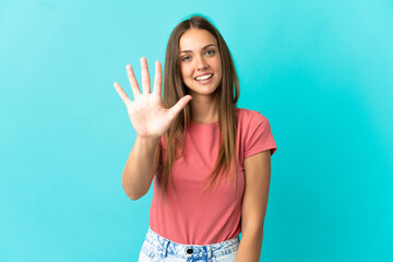 Young woman over isolated blue background counting five with fingers