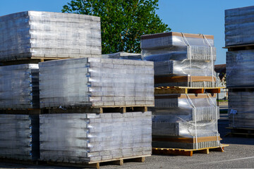 pallets stacked with cobblestones wrapped in transparent plastic film