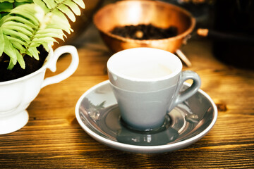 Coffee cup and beans on old vintage table. Top view with copy space for your text into the background.	
