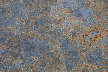 Vintage wall with weathered colors and rust. Blue, grey and orange granite background . Old colorful textured surface like corrosion. Abstract grunge rusty metallic backdrop for multiple uses