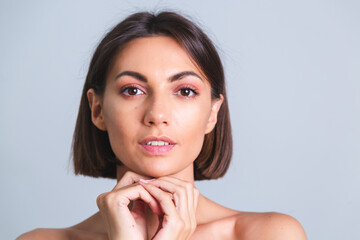 Fototapeta premium Natural beauty, portrait of topless woman with makeup and soft gentle tanned skin on gray background