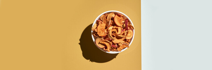 Crispy dried food. Organic tasty chips. Homemade snacks. Sliced apples. Healthy fruit. Two area. Orange pile. Trend natural dish. Horizontal banner. Copyspace