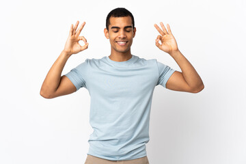 Fototapeta premium African American man over isolated white background in zen pose