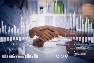 Businesswomen handshake in office room, stock market changes