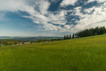 Obraz premium Meadows and forests near Javornik hill and village in Sumava national park