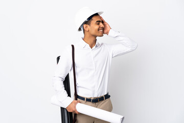 African American architect man with helmet and holding blueprints over isolated white background _ smiling a lot