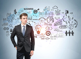 Businessman in suit, hand in pocket, business strategy sketch on blue wall