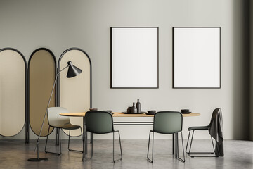 Light grey dining room interior with two posters