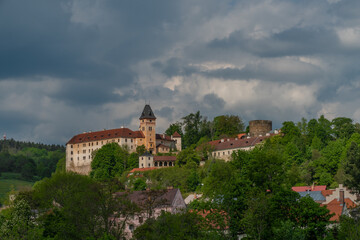 Fototapeta na wymiar Castle on big hill in Vimperk town in spring sunny and cloudy day
