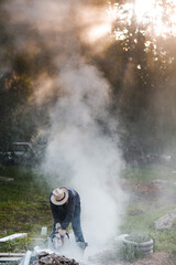 Obraz premium Worker mason cuts the sidewalk tile with circular saw while repairing sidewalk in city street.