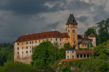 Fototapeta premium Castle on big hill in Vimperk town in spring sunny and cloudy day