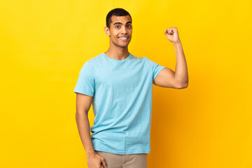 African American man over isolated background doing strong gesture