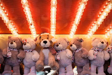 Stuffed toy bears on display awarded as winning prizes at Christmas funfair winter wonderland in...