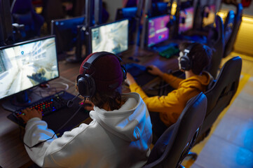 Two young gamers play in game club