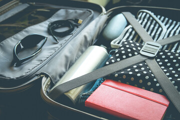 Open vintage suitcase full of clothes