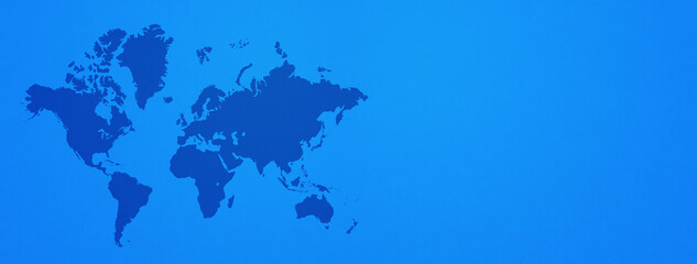 World map on blue wall background. Horizontal banner