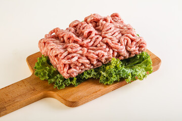 Raw pork minced meat over board
