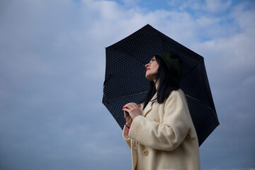 Happy woman with umbrella. Celebration. Sky background. 