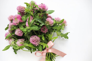 postcard mockup. bouquet of pink clovers on a white background and space for text 