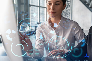 Two colleagues in formal wear working together to optimize business process by applying new technologies. Hi tech holograms over modern office background with panoramic windows