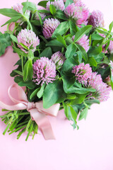 postcard mockup. bouquet of pink clovers on a white background and space for text 
