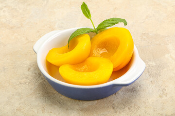 Sweet ripe canned peaches with mint