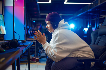 Young gamer resting in gaming armchair, game club © Nomad_Soul