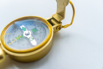 Banner of golden compass isolated, shallow DOF, focus on dial. Compass on a white background....