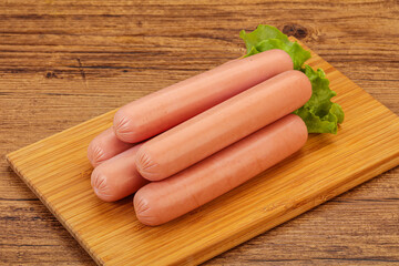 Tasty meat sausages over board