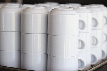 Many rows of pure white coffee cups on tray