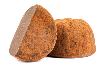 Chocolate truffles are whole and half are isolated on a white background.